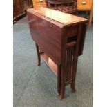 A late Victorian mahogany sutherland table, the moulded top with drop leaves having canted