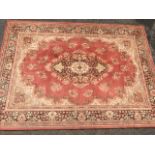 A Belgium made Kashmir style wool rug, the pink field with oval floral medallion having pale