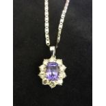 An 18ct gold tanzanite & diamond pendant, the rectangular claw set tanzanite weighing five carats,