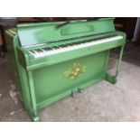 A 1950s painted Minx miniature piano, the green case with floral painted decoration having