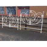 A 5ft painted wrought iron double bed, the headboard & tailboard of decorative scrolled design