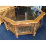 A contemporary octagonal coffee table, with bevelled plate glass in scalloped frame inset with brass