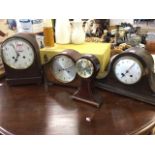 A larger domed clock with clear enamelled dial under convex glass with brass bezel; a Smiths