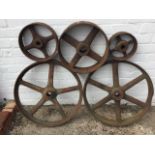Five cast iron belt wheels with flat rims and tapering axels - 23in, 15.5in, 12.75in & 8.5in dia) (