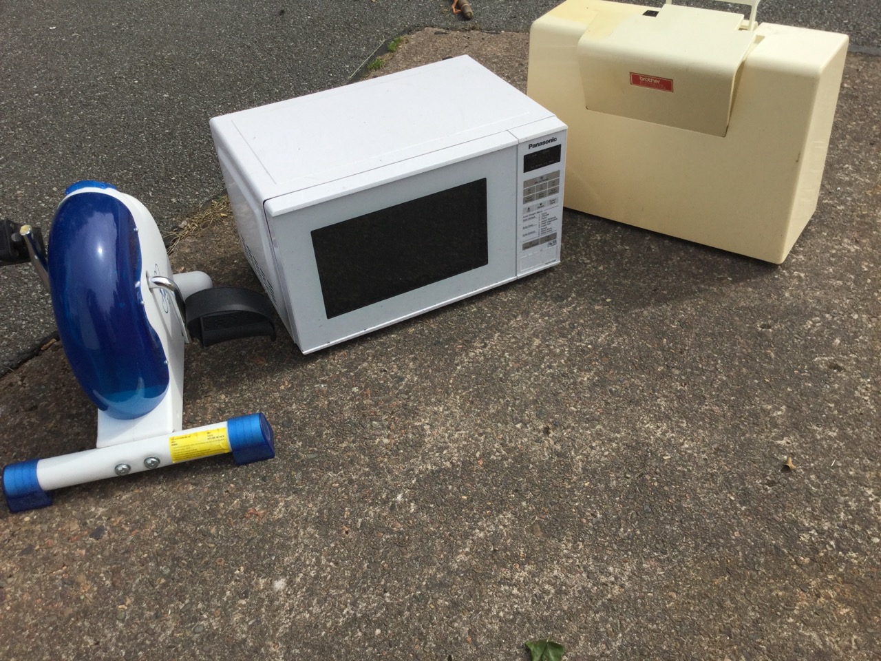 A cased Brother sewing machine; a Panasonic microwave oven; and a Bavina pedal exercise machine. ( - Image 2 of 3