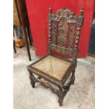 A nineteenth century Carolean style childs chair, the back carved with scrolls around a pierced