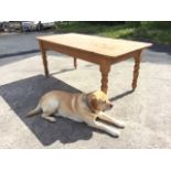 A dowel jointed pine kitchen table with rectangular rounded top on turned legs. (72in x 35.5in x