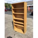 A reproduction oak open bookcase with five adjustable shelves. (30.25in x 13in x 65.5in)