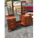 A 60s mahogany dressing table with three rectangular mirrors to back, the central section with