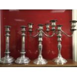 A pair of Welsh silver plated candelabra, each with three urn shaped candleholders with ribbed