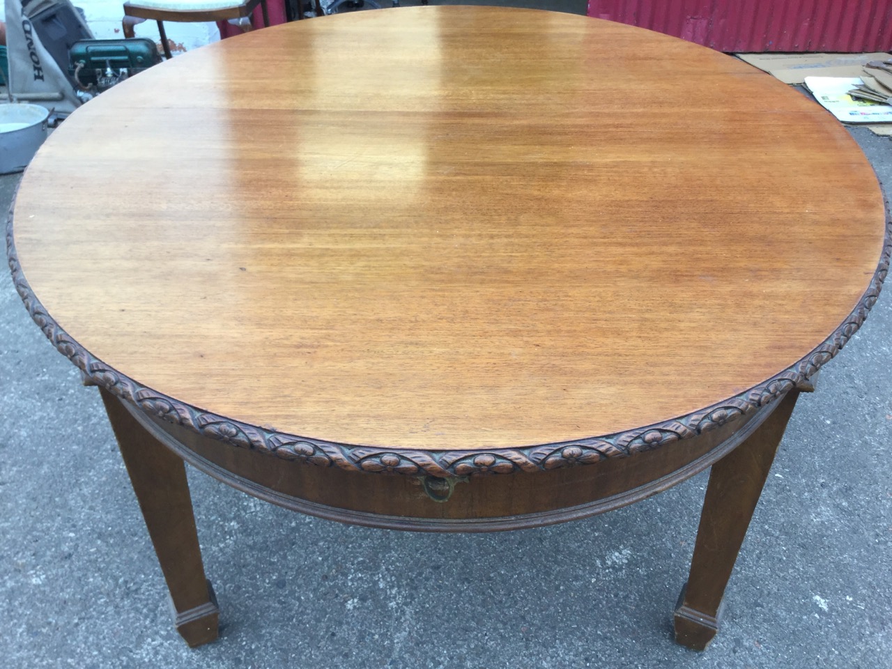 A late Victorian mahogany dining table, the oval top with flowerhead carved edge above a plain - Image 3 of 3