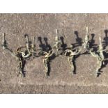 A set of four Edwardian brass rococo cast wall-lights, each with two scrolled pierced branches