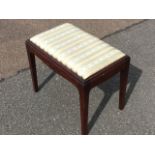 A rectangular reproduction mahogany stool with drop-in upholstered seat in moulded rails and