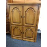 A French oak office desk, the cabinet with arched fielded panelled doors enclosing a fitted interior
