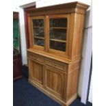 An Edwardian French cherrywood dresser, with moulded cornice above glazed doors enclosing shelves,