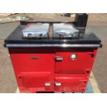 A Rayburn oil fired enamelled stove, model GD80, having twin hobs with chrome covers and two