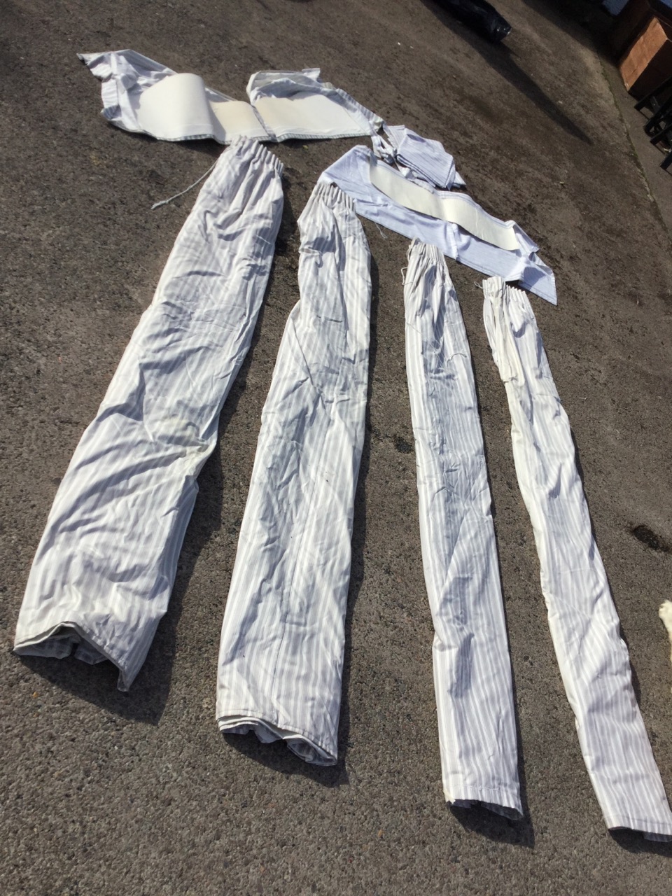 A set of four grey striped lined cotton curtains, with a pair of part-made pelmets, tie-backs, spare