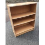 A faux beech open bookcase with adjustable shelves. (27in x 11.5in x 34in)