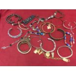 A collection of bracelets and bangles including one gold, hallmarked silver, paste, coral mounted,