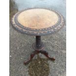 A circular Victorian mahogany occasional table, the top with carved border supported on a tapering