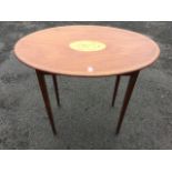 An oval Edwardian mahogany occasional table, the top inlaid with oval shell paterae within a boxwood