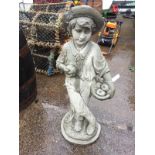 A composition stone figure of a young boy with basket of apples, standing by treestump on circular