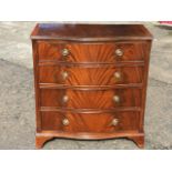 A reproduction serpentine fronted mahogany chest of drawers, the crossbanded top above four