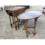 A rectangular rounded oak dining table, the moulded top with drop leaves raised on barleytwist