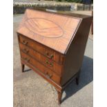 A Georgian style mahogany bureau, the fallfront with oval beaded panel enclosing a fitted interior