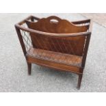 A regency style mahogany cantebury with brass grill panels in moulded ribbed frames having shaped