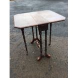 A late Victorian walnut sutherland table, the two drop-flaps with canted corners on hinged gates,