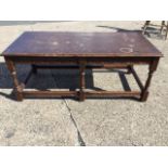 A rectangular oak coffee table, the moulded top above an arched carved frieze, raised on six