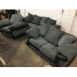 A corduroy three-piece suite with grey loose cushions and black faux leather arms - a three-seater