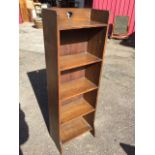 An art nouveau oak bookcase with heart cut to top above five shelves, raised on shaped feet. (15.