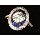 A cased art deco style Sterling silver ring mounted with oval panel of faux sapphires & diamonds,