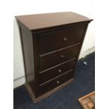 A rectangular mahogany shoe cabinet with two drop-down fallfront compartments modelled as drawers,