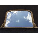 A Victorian gilt overmantel mirror, the rounded moulded frame on plinth, flanked by scroll carved