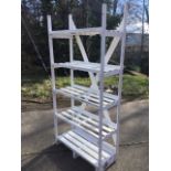 A painted storage rack with five slatted lipped shelves. (35.5in x 16in x 74.5in)