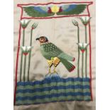 A stylised crewelwork panel sewn in coloured wools depicting the Egyptian god Hours as a falcon, the