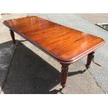 A reproduction Victorian style extending wind-out mahogany dining table, the rectangular moulded top