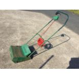 A Qualcast electric garden scarifier, the push-along electric lawn machine with roller.
