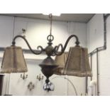 An Edwardian hanging light fitting with chain supporting boss with leaf style mounts, having three