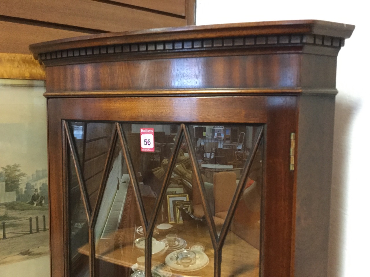 A bowfronted mahogany corner cabinet with moulded dentil cornice above an astragal glazed door - Image 3 of 3