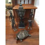 A bronze tortoise with articulated head & tail; a pair of bronze African tribal figures modelled