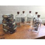 Five American glass storage jars with cork stoppers - vodka, rum, scotch, gin & brandy; and a
