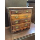 A miniature late Victorian mahogany chest of two short and three long fielded panelled drawers,