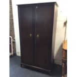 A Stag mahogany wardrobe, the fielded panelled doors mounted with brass ring handles enclosing