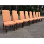 A set of eight Georgian style upholstered mahogany dining chairs, the shaped padded brass studded