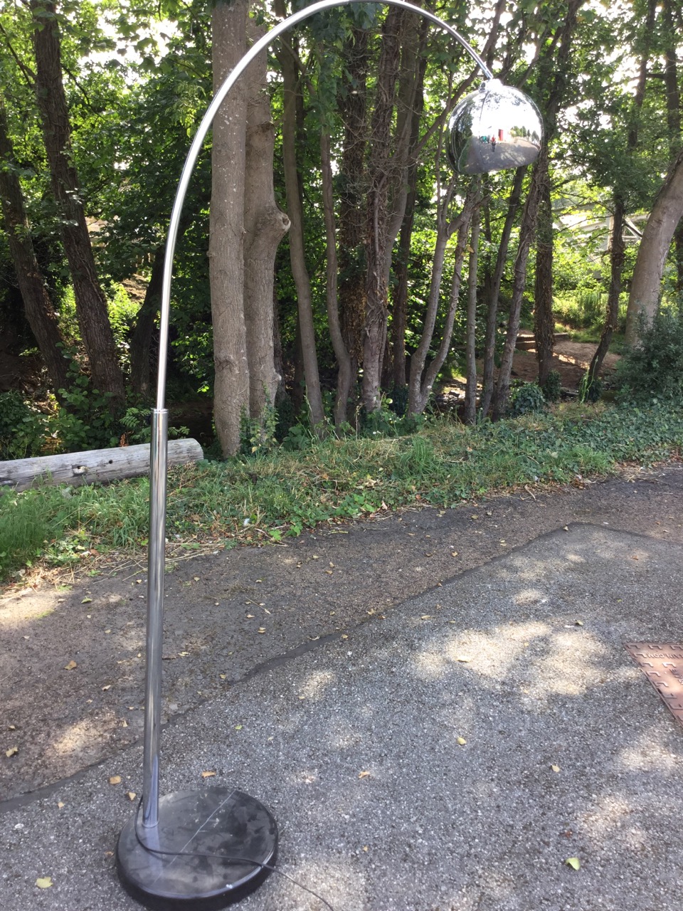 A designer Italian floor lamp, with circular polished marble base supporting chrome column with