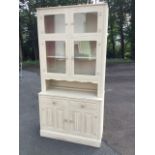 A painted Old Charm carved oak dresser, the top with glazed doors above a base with two ribbed